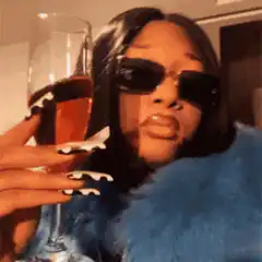 Woman in sunglasses sipping champagne