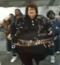 Fat Elvis dancing with backup dancers