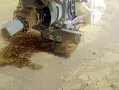 Mars rover drill digging into ground