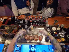 Bartender serving four drinks
