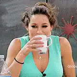 Woman laughs while drinking coffee