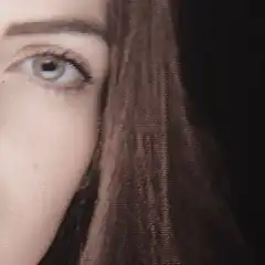 Close-up of a woman's eye and hair