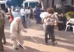Elderly man dancing with cane