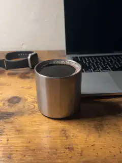 coffee cup on desk with laptop