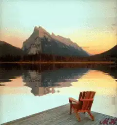 Wooden chair on dock at sunset