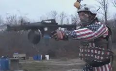 Man in American Flag Gear Firing Rocket Launcher