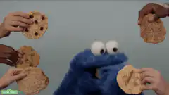 Cookie Monster eats cookies from hands