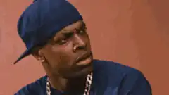 Man in blue cap facepalms