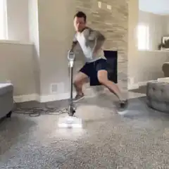 man dancing with vacuum cleaner