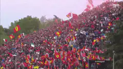 Massive crowd waving red flags