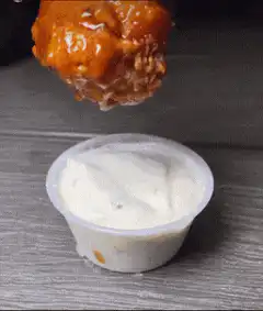 Buffalo wing dipped in ranch dressing