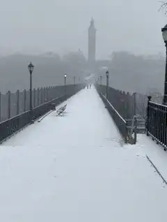 Snowy bridge with clock tower