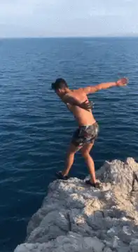 Man cliff jumps into ocean