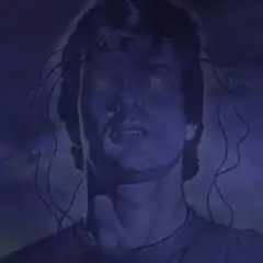 Man with glowing eyes and wires