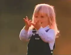 Toddler blows up orange balloon