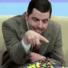 Mr. Bean points at candy