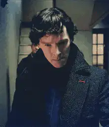 Sherlock Holmes puts on deerstalker hat