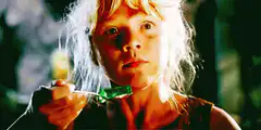 Young girl holding green lollipop