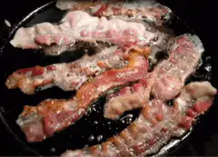 bacon sizzling in a pan