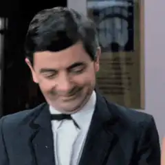 Mr. Bean smirking and looking surprised