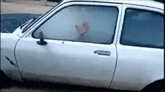 Man clears fog from car window