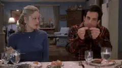 Ben Stiller eating a hot dog at dinner