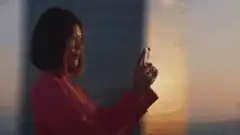 Woman zooming in on city with phone