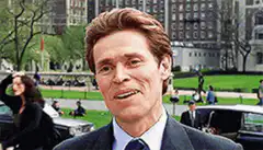 Willem Dafoe smirking in Central Park
