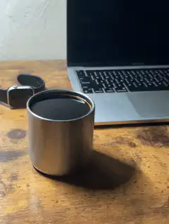 coffee cup and laptop on desk