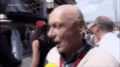 Niki Lauda puts on red cap