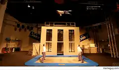 Two people jumping on a trampoline