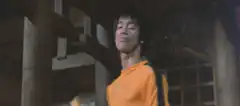 Bruce Lee in orange shirt