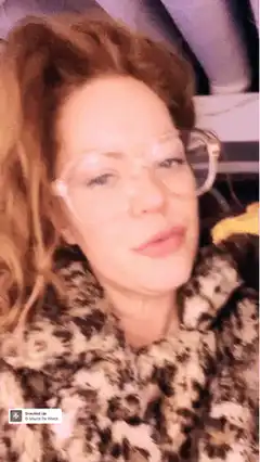 Woman in leopard print eating pizza