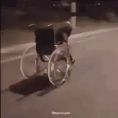 Man in wheelchair doing a wheelie