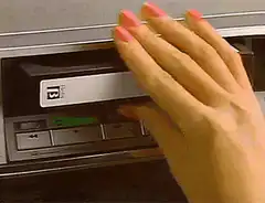 Hand inserting a VHS tape
