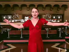 Reese Witherspoon in red dress singing