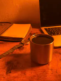 coffee cup on desk with laptop