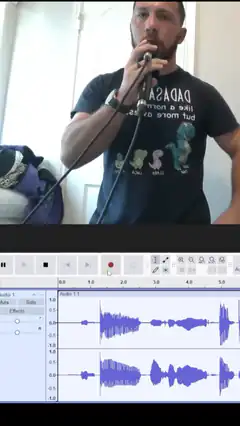 Man singing into microphone with audio waveform