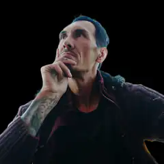 Man with tattoo looking up thoughtfully