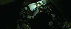 Person typing at a desk full of computers