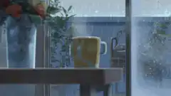 Steaming mug by rainy window
