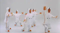 people in white astronaut suits dancing