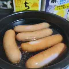 Sausages boiling in a pot