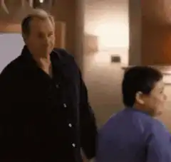 Man sprays boy with water bottle