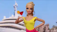 Barbie holding a cocktail on a yacht