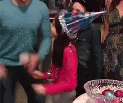 Girl gets hit in face with party hat