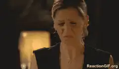 Woman makes disgusted face and sticks out tongue