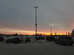 sunset over a snowy parking lot