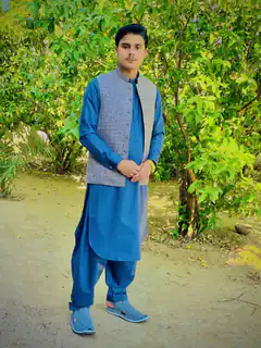 Man in blue shalwar kameez outdoors