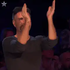 Simon Cowell clapping and giving thumbs up